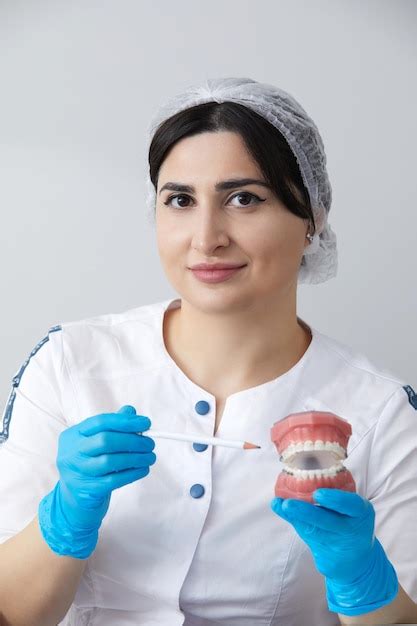 Premium Photo Orthodontist Showing Model Of Human Jaw With Wire