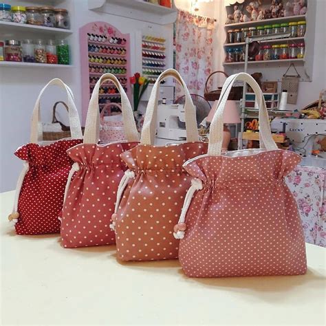 Four Bags Sitting On Top Of A Table In Front Of A Store Display Case