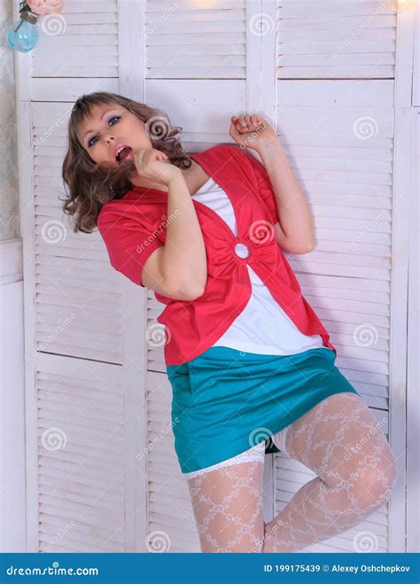 Blonde Model In White Stockings And Green Miniskirt Posing In Studio Stock Image Image Of