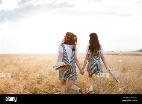 2 Sisters Holding Hands