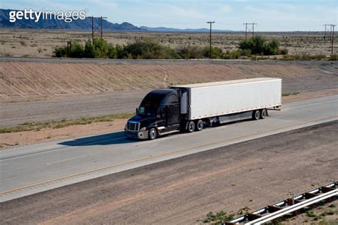 Drone View Of A Long Haul Semi Truck Speeding Down A Four Lane Highway