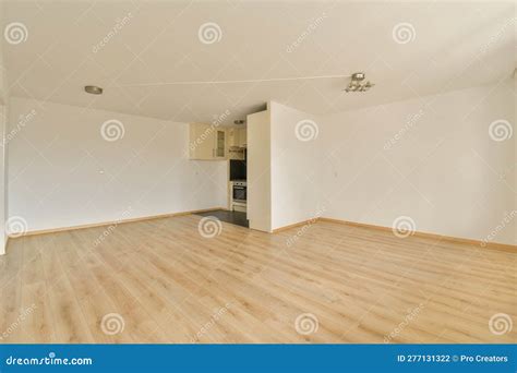 An Empty Living Room with Wood Floors and a Kitchen Stock Photo - Image ...