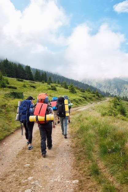 Premium Photo Group Of Hikers With Backpacks On A Path Through The