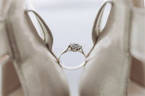 Nude Elegant Shoes A Diamond Engagement Ring Sits Between A Pair Of Classic Bridal Shoes Stock