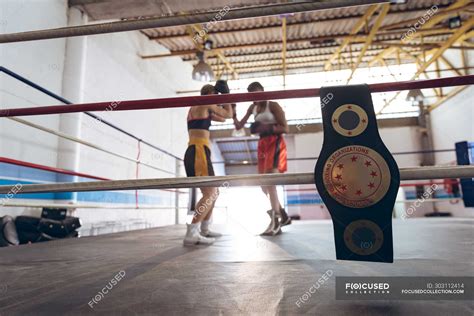 Two Female Boxers Fighting In Boxing Ring At Fitness Center Strong