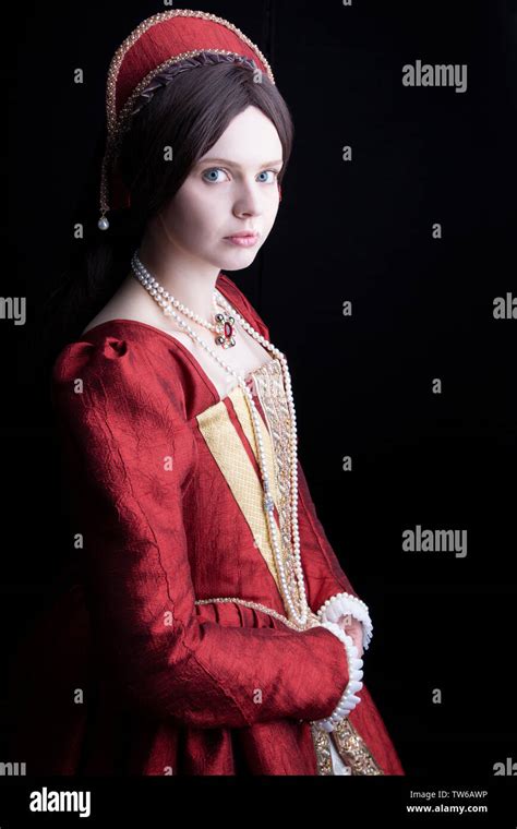 Tudor Woman In Red Dress Walking In Garden Stock Photo Alamy