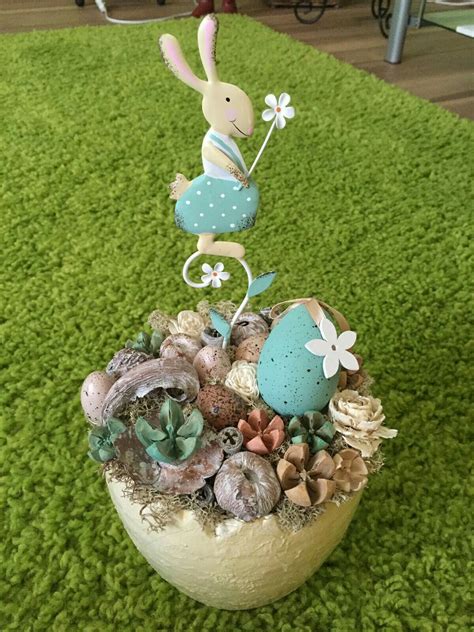 A Basket Filled With Shells And Plants On Top Of A Green Rug