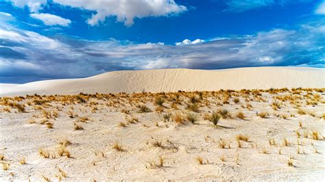 Download Wallpaper 3840x2160 Desert Sand Grass Dry Sky Clouds 4k