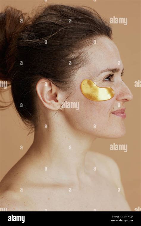 Happy Modern 40 Years Old Woman With Eye Patches Isolated On Beige