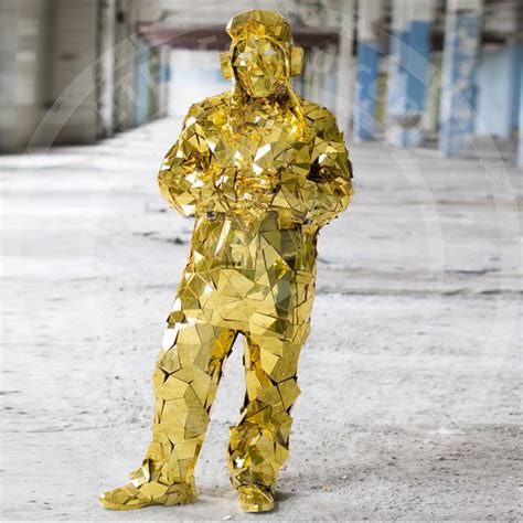 A Man In A Gold Suit Standing On The Street