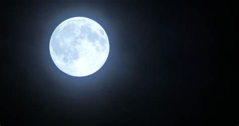 Stock Video Clip Of Beautiful Full Moon Shining Through Moving Blue