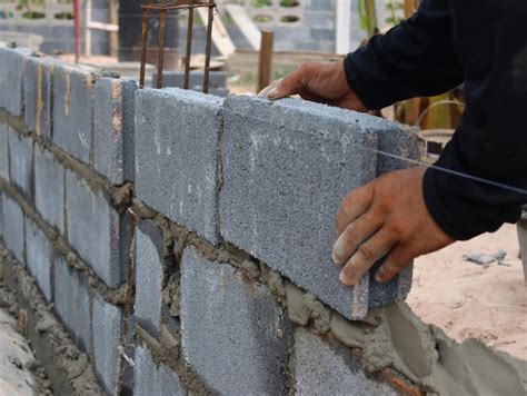premium photo close   man holding retaining wall