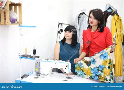 Beautiful Girl in a Red Dress in a Tailoring Studio. Exclusive ...