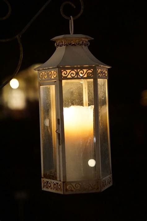 A Lit Candle Hanging From A Light Fixture