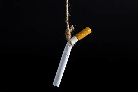 Premium Photo Close Up Of Cigarette Against Black Background