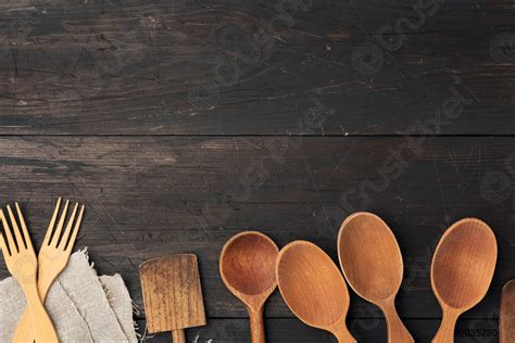 Empty wooden spoons, forks and spatulas on a brown wooden - stock photo ...