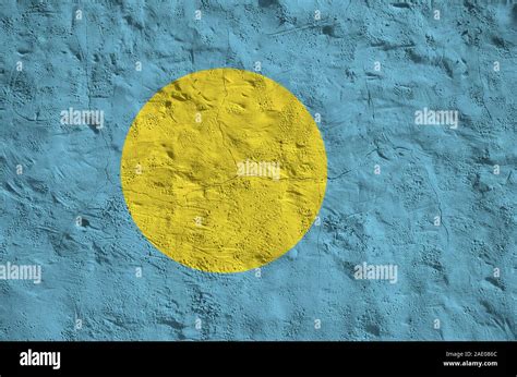 Palau Flag Depicted In Bright Paint Colors On Old Relief Plastering