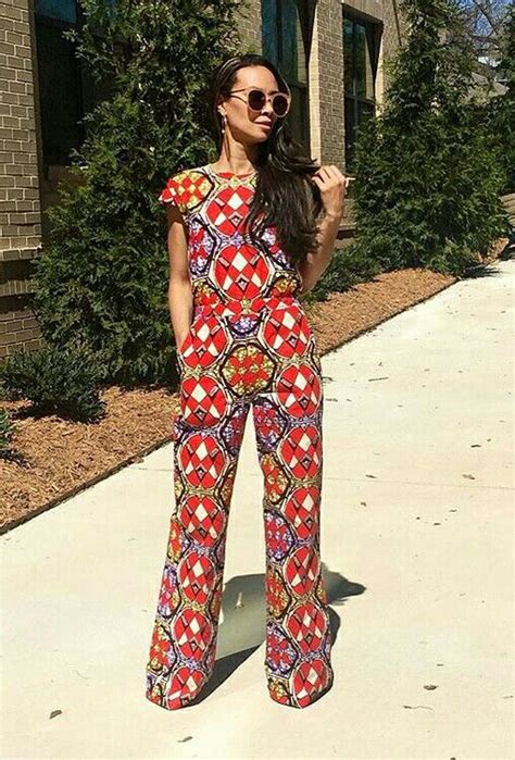 A Woman Standing In Front Of A Building Wearing Red And Blue Patterned