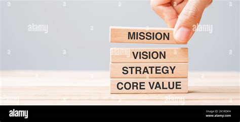 Business Man Hand Holding Wooden Block With Mission Vision Strategy