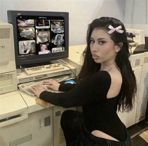 A Woman Sitting In Front Of An Old Computer