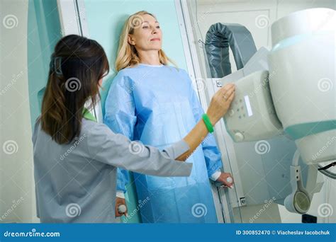 Experienced Radiologic Technologist Preparing Female Patient For