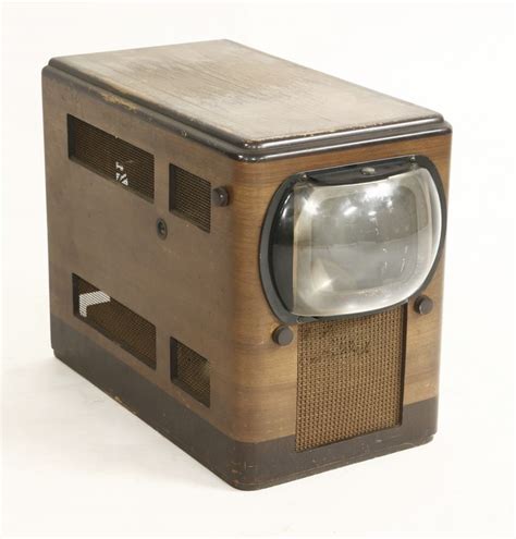 An Old Fashioned Tv Sitting On Top Of A Wooden Stand With A Magnifying Glass In It