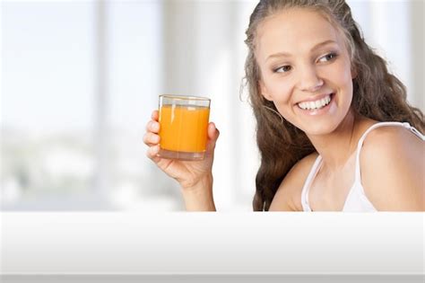 Premium Photo Attractive Young Woman Holding Glass Of Fresh Juice