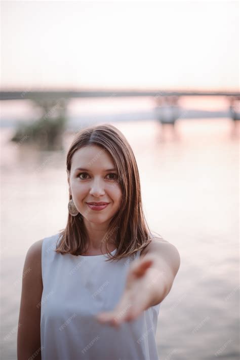 Premium Photo A Happy Smiling Caucasian Woman Stretches Out Her Hand