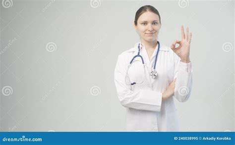 Portrait Of An Attractive Young Female Doctor In White Coat Stock