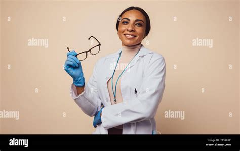 Successful Female Doctor On Brown Background Woman Doctor Wearing Lab