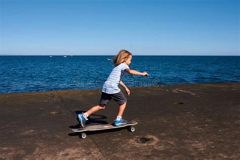 Boy Riding A Longboard On A Pier At Sunny Day Stock Photo Image Of