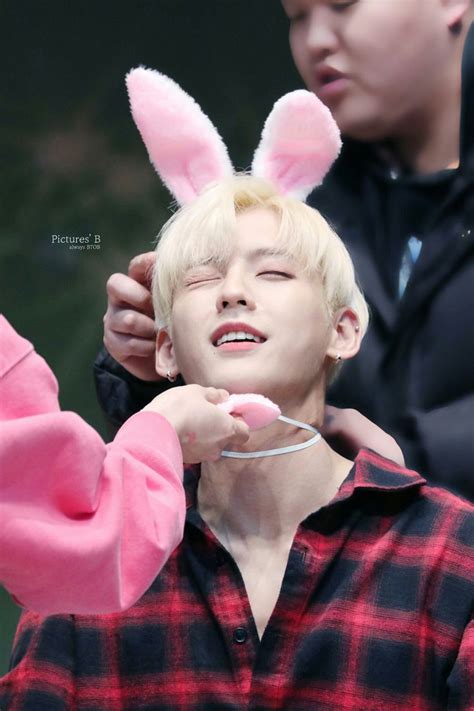 A Man With Bunny Ears Is Getting His Hair Brushed By Another Person Who