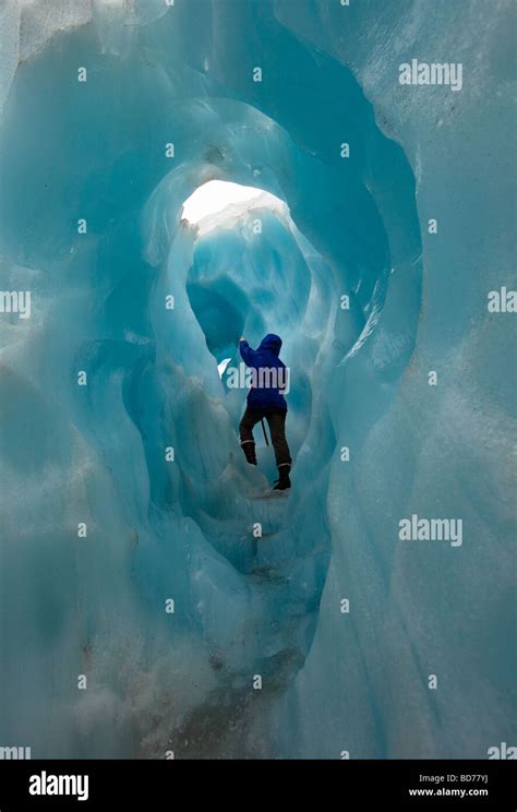 Franz Josef Glacier New Zealand Hiker In Small Ice Tunnel On Franz