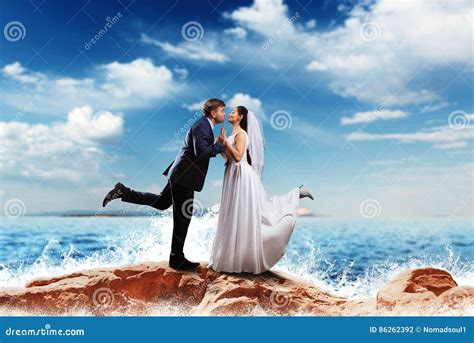 Bride And Groom Kissing On The Sea Shore Stock Photo Image Of Happy