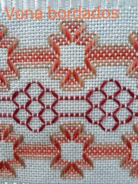 An Orange And White Cross Stitch Pattern With Red Thread On The Bottom