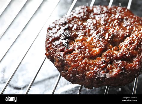 Burger patty on grill, closeup Stock Photo - Alamy