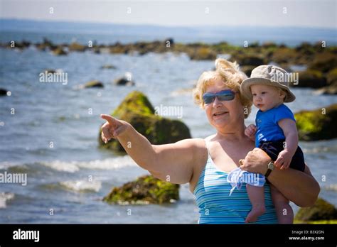 Grandmother Holding Her Grandson At The Beach Stock Photo Alamy