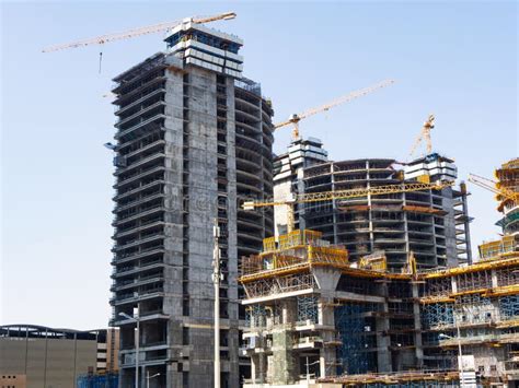 High Rise Buildings Under Construction With Cranes And Scaffolding