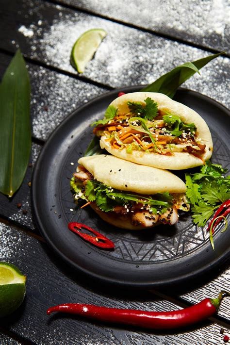 Asian Dish On A Black Plate Bao With Meat And Vegetables Stock Image