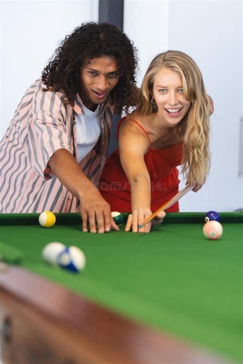 Biracial Man Teaches A Caucasian Woman How To Play Pool Both Smiling