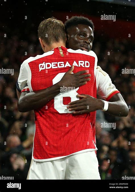 Arsenals Bukayo Saka Right Celebrates With Martin Odegaard After