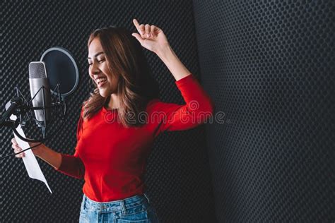 Pretty Asian Female Singer Recording Songs By Using A Studio Microphone