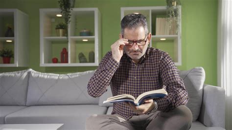 Mature Man Reading A Book At Home On A Sunny Day Happy Senior Mature