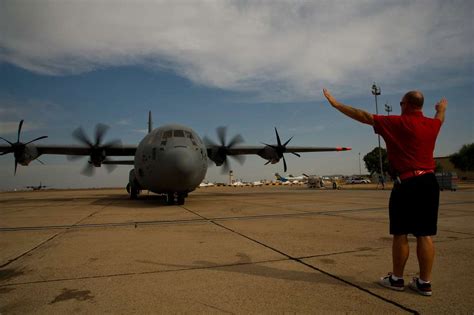 A Ground Crew Member Directs A Military C 130 From PICRYL Public