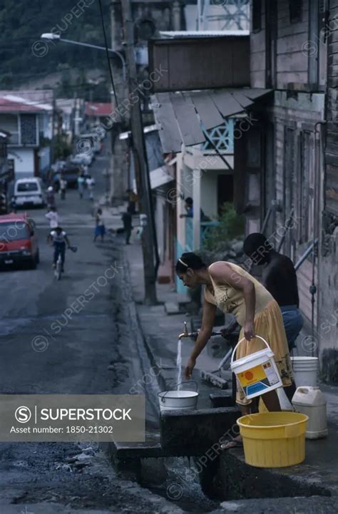 St Lucia Soufriere Man And Woman Collecting Water From Standpipe In