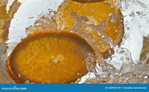 Orange Slices Falling Glass Liquid Closeup Making Fizzy Citrus Cocktail In Cup Stock Image