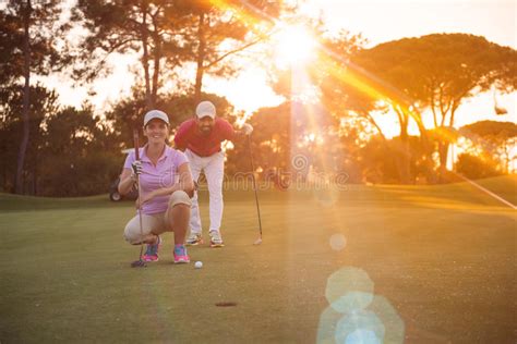 Couple On Golf Course At Sunset Stock Image Image Of Active Female