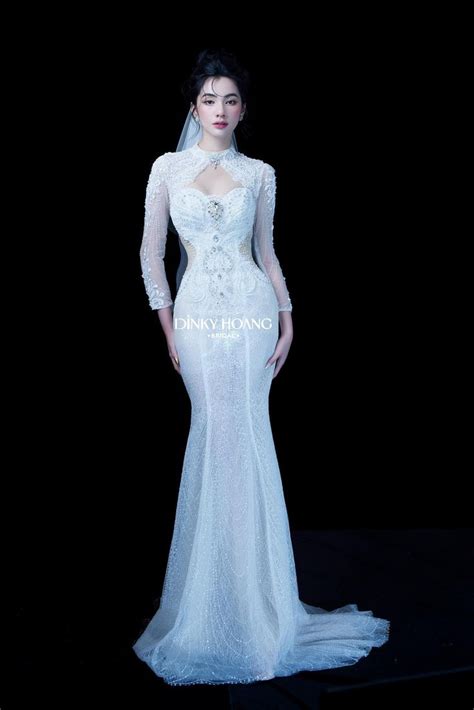 A Woman In A White Wedding Dress Standing On A Black Background