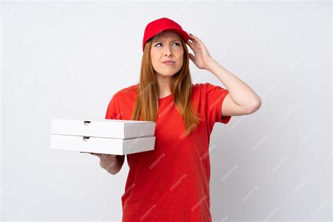 Premium Photo Pizza Delivery Woman Holding A Pizza Over Isolated Pink Wall Having Doubts And