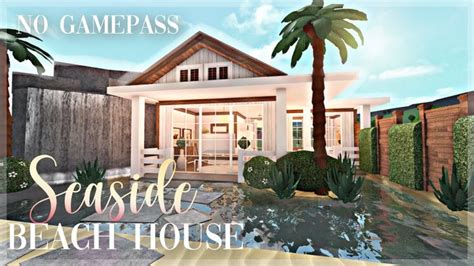 A Beach House With Palm Trees In Front Of It And The Words Sea Side